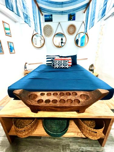 a bedroom with a bed on a wooden table at Kasa Gigi in El Nido