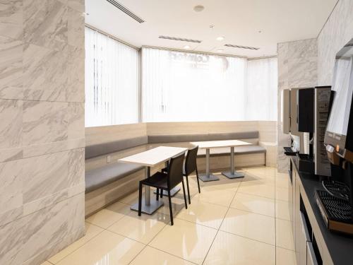 a conference room with two tables and a window at Comfort Inn Nagoya Sakae in Nagoya