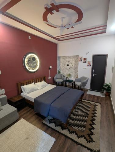 a bedroom with a large bed and a red wall at Kassy homestay in Udaipur