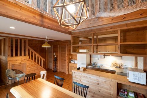 a kitchen and dining room with a table and chairs at yado suzuka in Suzuka
