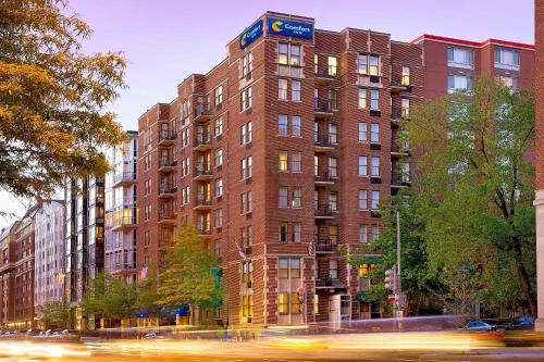 a tall red brick building with a blue sign on it at Comfort Inn Downtown DC-Convention Center in Washington, D.C.