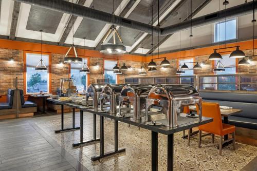 a restaurant with a row of dishes on a table at Amsterdam Inn & Suites, an Ascend Collection Hotel in Florenceville