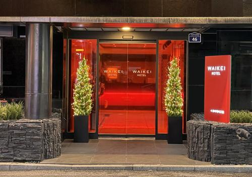 a glass door of a building with christmas trees outside at Waikei Hotel in Suwon