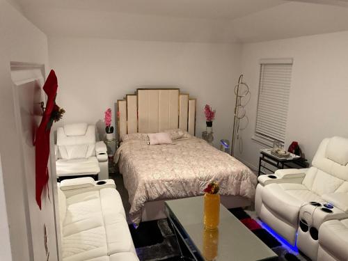 a bedroom with a bed and two chairs and a couch at Homely in Richmond