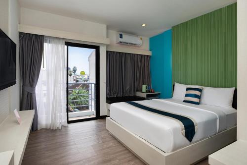 En eller flere senge i et værelse på iCheck inn Chill Patong