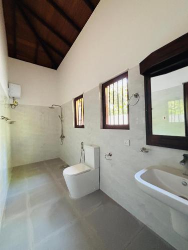 a bathroom with a toilet and a sink and a tub at Legacy Weligama - 8 min to Weligama Beach in Weligama