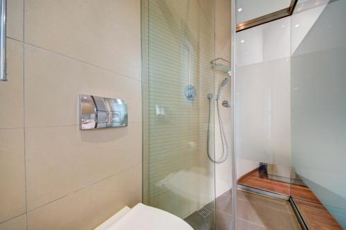 a bathroom with a shower and a toilet at St Julian's 2Br Apartment with Private Jacuzzi in St. Julianʼs