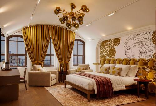 a bedroom with a large bed and a chandelier at Castellion Hotels Galata in Istanbul