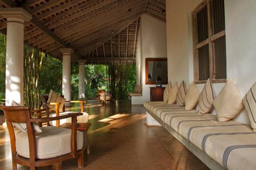 a living room with couches and tables and chairs at Wallawwa in Katunayake
