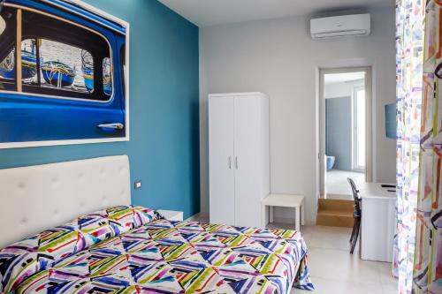 a bedroom with a bed and a blue wall at Bocca di Bacco in Cimitile