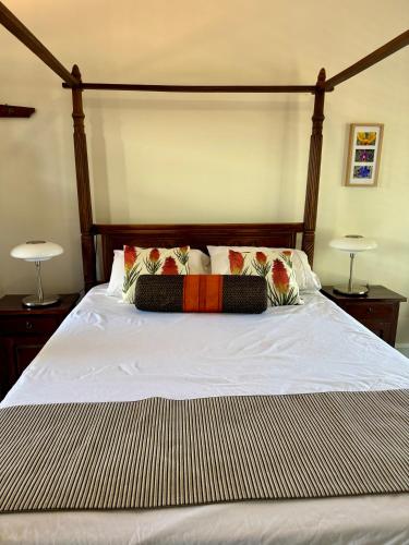 a bed with two lamps and two pillows on it at York Wildflower Junior Suite in York