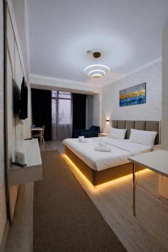 a bedroom with a large bed in a room at BALAND HOTEL DUSHANBE in Dushanbe