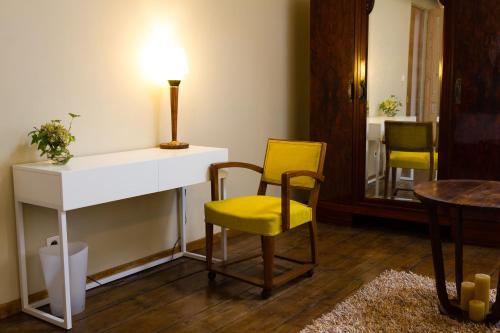 a room with a table and two chairs and a lamp at Wazemoff in Lille