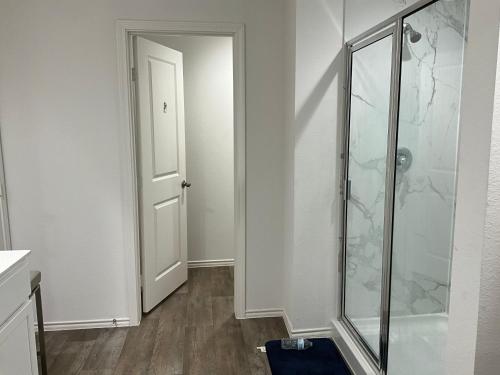 a bathroom with a shower and a glass door at Homely in Richmond
