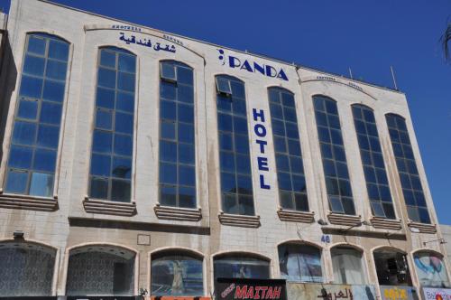 un edificio con un cartel en el costado en Panda Hotel Apartments, en Amán