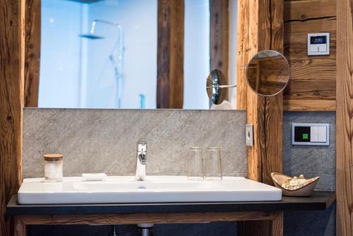 a bathroom with a sink and a mirror at Aurina Lodges in Lutago