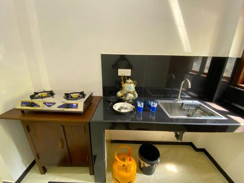 a small kitchen with a counter and a sink at Green Calm Villa in Kamburugamuwa
