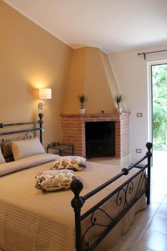 a bedroom with two beds and a fireplace at Sea Garden Rooms in Termoli