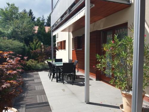 a patio with a table and chairs on a house at Baláca Panzió in Veszprém