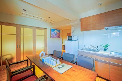 eine Küche mit einem Holztisch und einem Esszimmer in der Unterkunft 中野ワールドホテル in Tokio