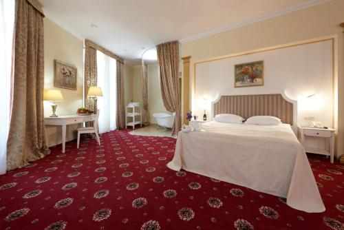 a hotel room with a bed and a bathroom at City Holiday Resort & SPA in Kyiv
