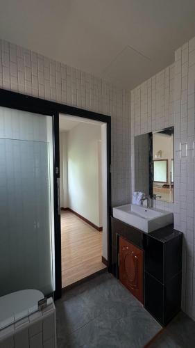 a bathroom with a sink and a mirror at PS Lanta Resort in Phra Ae beach