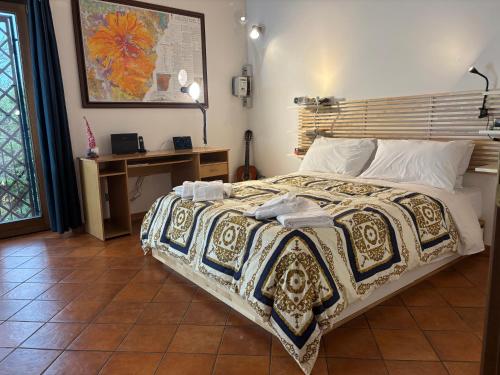 a bedroom with a bed with a blanket on it at Soffio dell'Etna in Puntalazzo