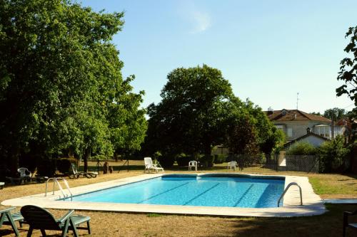 a swimming pool in the yard of a house at Pazo Almuzara in Boborás