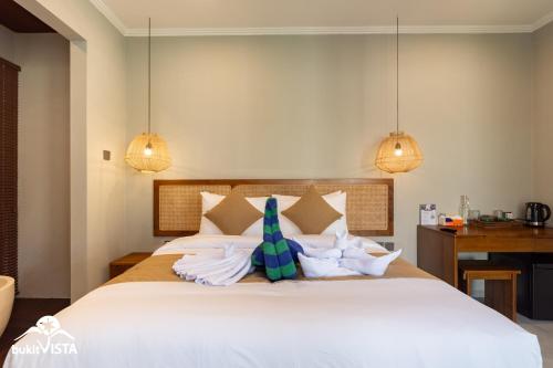 a bedroom with a large white bed with pillows at Soocha B by Bukit Vista in Ungasan