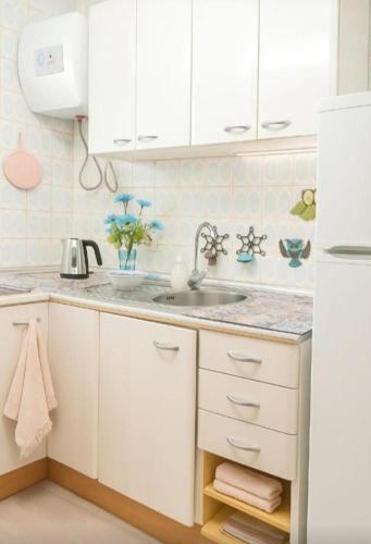a kitchen with white cabinets and a sink at Arguinegin Gran Canaria Near the Beach with ocean view in Arguineguín