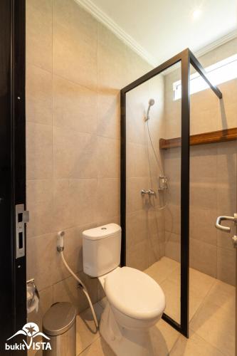 a bathroom with a toilet and a shower at Soocha C by Bukit Vista in Ungasan