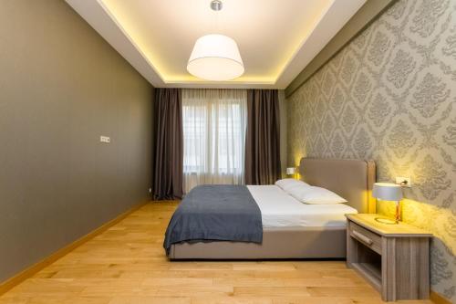 Кровать или кровати в номере Luxury Apartment III