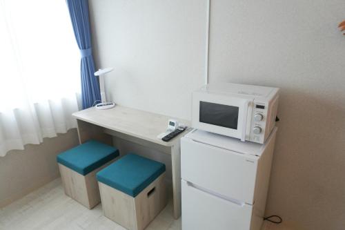 Kuchyň nebo kuchyňský kout v ubytování 還元ホテル 名護東江