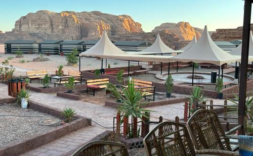 a group of white tents with tables and chairs at Rotana camp in Disah