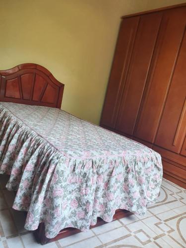 a bedroom with a bed with a blanket on it at Quarto privativo em Araruama in Araruama