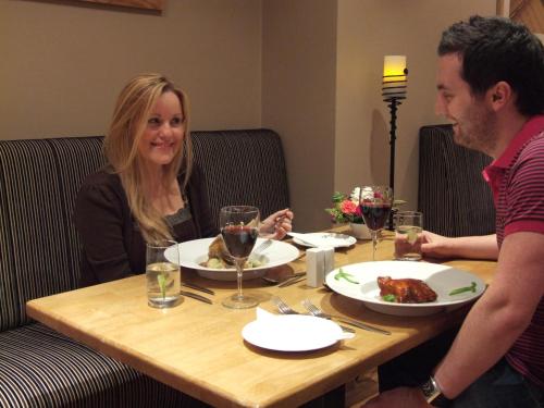 a man and woman sitting at a table with food at Murphy's Hotel in Tobercurry
