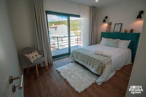 En eller flere senge i et værelse på Apartamentos da Travessa T3