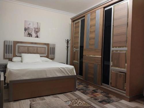 a bedroom with a bed and a large closet at Luxury Apartment In Sheikh Zayed - Jannah 2 Compound in Sheikh Zayed