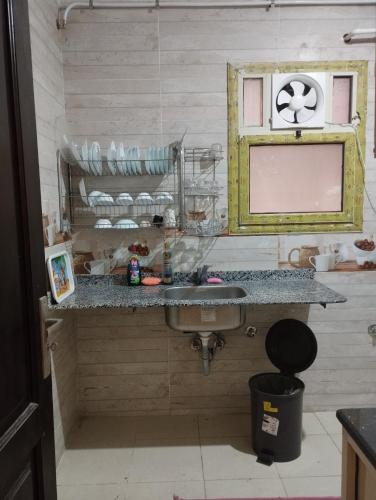 a bathroom with a sink and a mirror at Luxury Apartment In Sheikh Zayed - Jannah 2 Compound in Sheikh Zayed