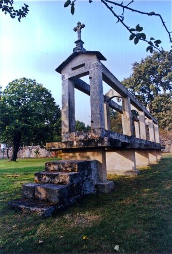 a monument in a park with a cross on top at Pazo Almuzara in Boborás