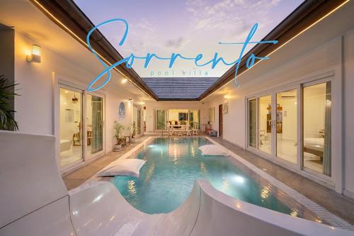 a swimming pool in the middle of a house at Sorrento Pool Villa Bang Lamung Pattaya in Ban Rong Po