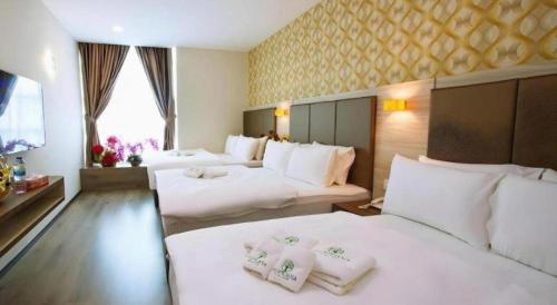 Postel nebo postele na pokoji v ubytování Tropicana Boutique Hotel