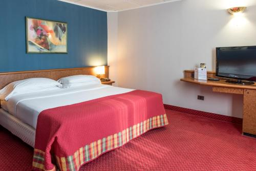 Кровать или кровати в номере Idea Hotel Piacenza