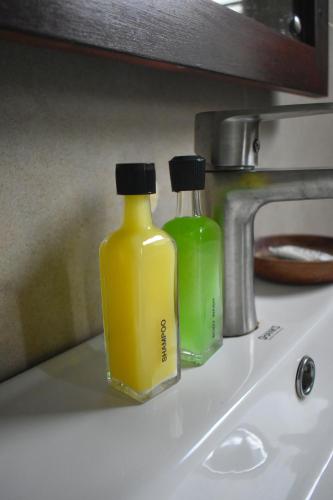 two bottles of detergent sitting on top of a sink at Sea Cloud Dalawalle in Unawatuna