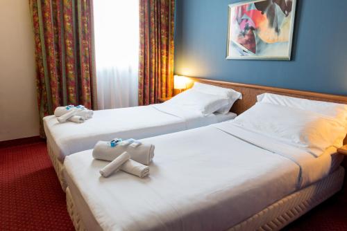 Кровать или кровати в номере Idea Hotel Piacenza