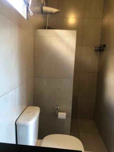 a bathroom with a toilet and a shower at Estância Hotel in Jardim