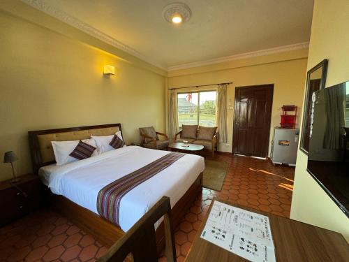 ein Hotelzimmer mit Bett und Fernseher in der Unterkunft Tise Hotel in Kathmandu