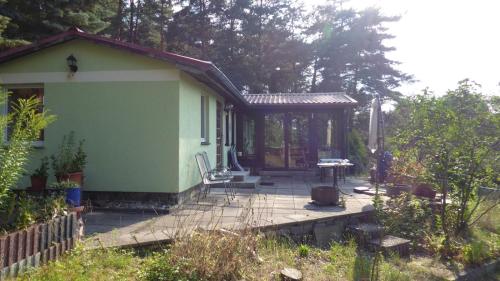 a small house with a porch and a patio at Bungalow am Küstrinsee bei Lychen in Lychen