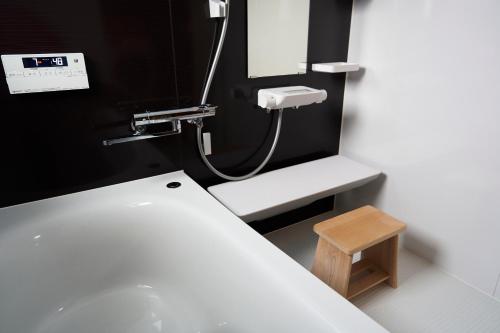 a bathroom with a white sink and a mirror at HETA Niseko in Niseko