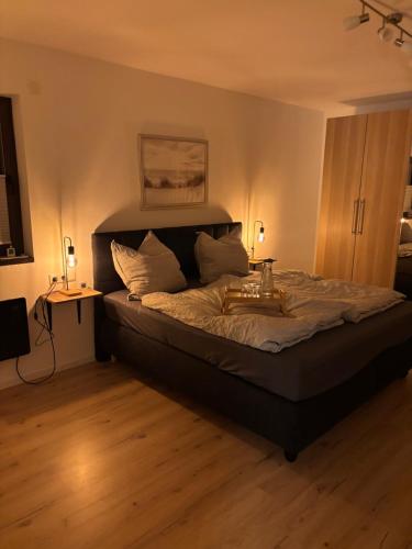 a bedroom with a bed with a tray on it at Ferienwohnung Auszeit am Waldrand in Olpe